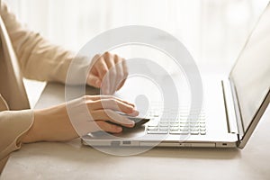 Woman working on computer close up. Woman hands typing on keyboard of laptop, online shopping detail. Business, remote