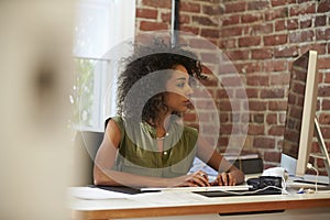 Woman Working At Computer In Contemporary Office