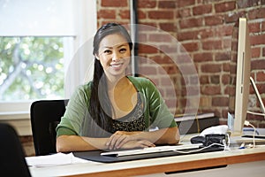 Woman Working At Computer In Contemporary Office