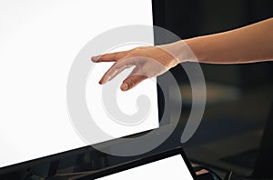 Woman working on computer with hand pointing at desktop screen.