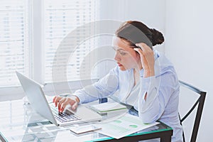 Woman working on computer in modern office