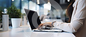 Woman working on computer in modern office, close up. Woman hands typing on keyboard of laptop, online shopping detail