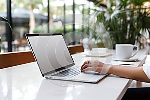 Woman working on computer in modern office, close up. Woman hands typing on keyboard of laptop, online shopping detail