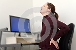 Woman Working on Computer Suffering from Back Pain