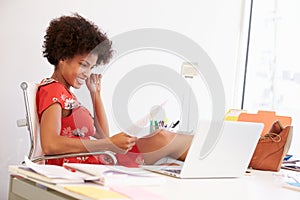 Woman Working At Desk In Design Studio