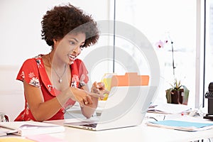 Woman Working At Desk In Design Studio