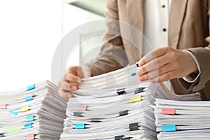 Woman working with documents in office