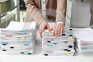 Woman working with documents at table in office