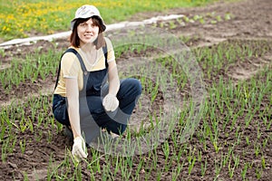 Woman working in field of onion