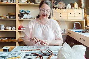 Woman working on a gemstone necklace as a hobby