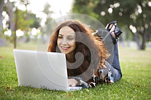 Woman working on her laptop in a park.