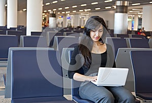 Woman working with her notebook in the airport