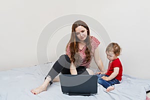 Woman working from home with her baby on lap