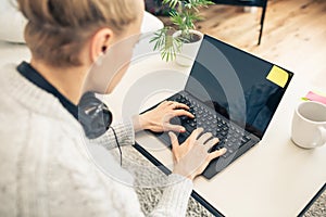 Woman working from home on laptop computer