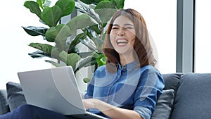 Woman working from home on laptop online meeting in home office. Entrepreneur asian business woman using notebook laptop sit on so