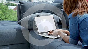 Woman working from home on laptop online meeting in home office. Entrepreneur asian business woman using notebook laptop sit on so