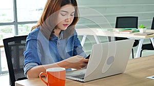 Woman working from home on laptop online meeting in home office. Entrepreneur asian business woman using notebook laptop sit on so