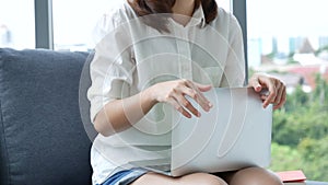 Woman working from home on laptop online meeting in home office. Entrepreneur asian business woman using notebook laptop sit on so