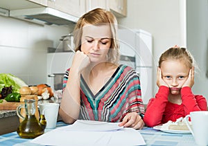 Woman working from home, little daughter asking for attention