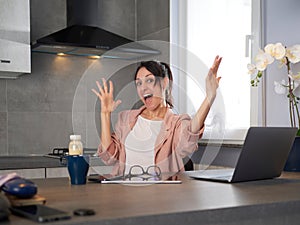 woman working at home office and celebrating success