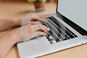 Woman working at home office hand on keyboard close up