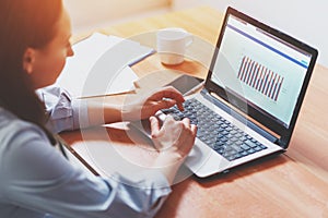 Woman working at home office hand on keyboard close up