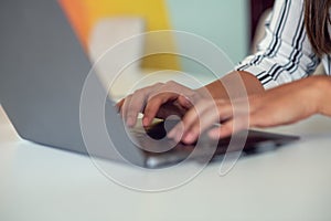 Woman working at home office hand on keyboard close up