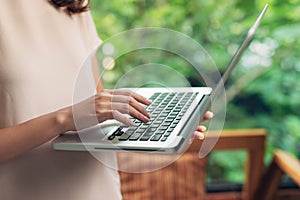 Woman working at home office hand on keyboard close up