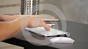 Woman working in home office hand on keyboard. Green Screen Mock-up Display.