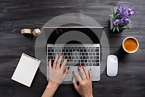 Woman working in home office hand on keyboard top view