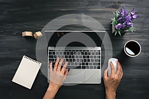 Woman working in home office hand on keyboard top view