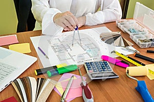 Woman working at house development with different tools.