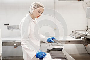 Woman working at ice cream factory