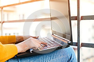 Woman working on a laptop on balcony, close up. Freelancer, remote work. Coronavirus quarantine