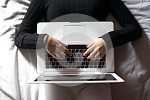 Woman working with the laptop in bed photo