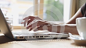 Woman working on laptop in the cafe