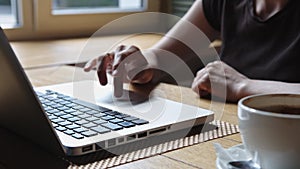 Woman working on laptop in the cafe