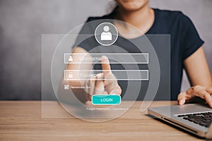 Woman working on laptop computer with login and password on screen display, cyber security concept