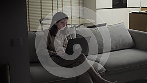 Woman working with laptop computer at night