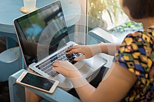 Woman working with laptop computer photo