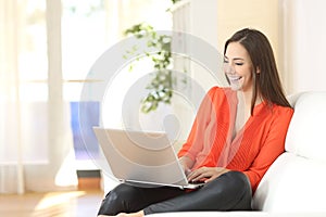 Woman working with a laptop at home