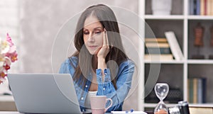 Woman working with laptop at home office