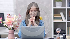 Woman working with laptop at home office