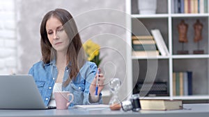 Woman working with laptop at home office
