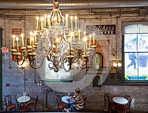 A woman working on laptop inside a coffee shop