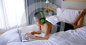 Woman working on laptop while listening to music 4k