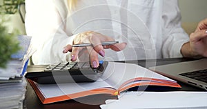 Woman working at laptop making calculations