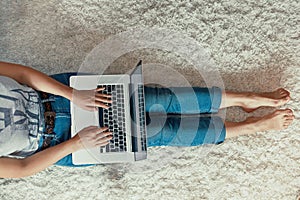 Woman  working on a laptop, online shoping, Payment. Female using a laptop sitting on floor,  searching web, browsing information,