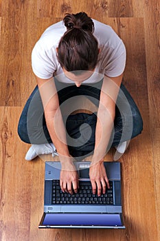 Woman working on laptop overhead