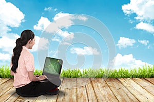 Woman working with laptop sit on the floor